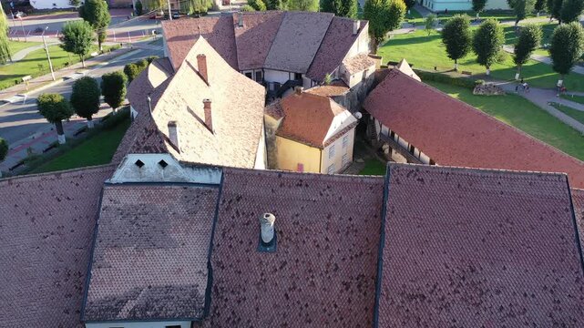 Aerial view of the Fortified church revealing the intricate layout and aged beauty, contrasted by the lush green courtyard, Prejmer, Brasov, Romania.