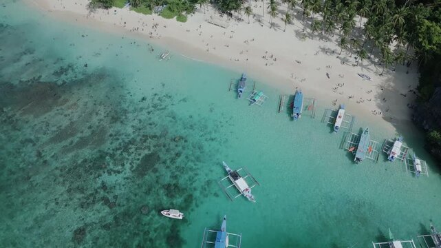 Aerial drone sweep from Seven Commandos Beach toward tropical coastline and horizon in El Nido
