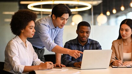 diverse team collaborating on laptop