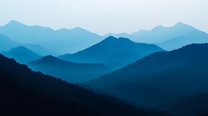 Fototapeta premium Silhouetted blue mountain range under a clear sky serene landscape backdrop