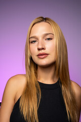 Close-up beauty portrait highlighting smooth, radiant skin, natural makeup, and a fresh healthy complexion in modern studio lighting.