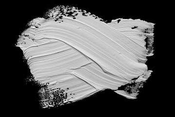 White abstract oil paint spot. White oil paint brush stroke on black background.