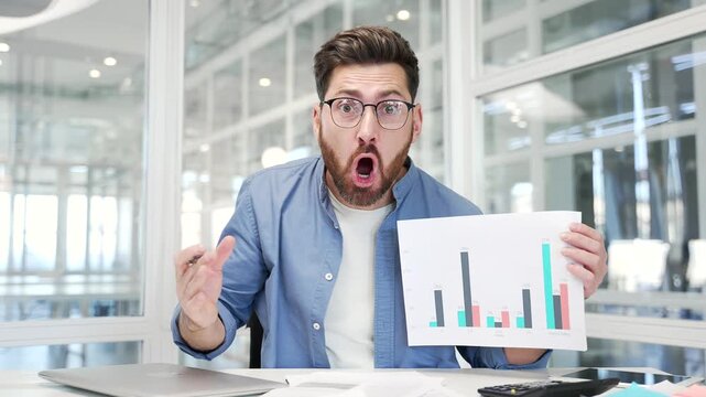 Webcam view. Angry businessman arguing talking on video call conference looking at camera in office. Dissatisfied boss scolds subordinates during an online meeting showing bad indicators data on chart