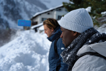 Two contemplative figures stand in a snowy landscape, exuding a sense of focus and introspection amidst the beauty of their natural surroundings.