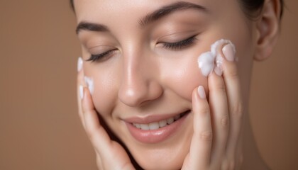 A close-up shot of a woman with white skincare cream on her cheek.