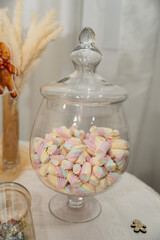 Colorful candy stored in a glass jar at a festive gathering