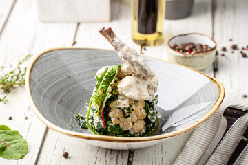 Creamy rabbit leg with cauliflower and greens