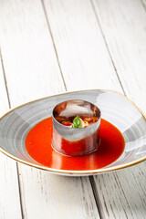 Modern tomato soup with basil garnish