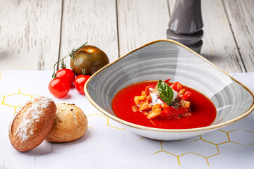 Gourmet tomato soup with fresh bread rolls