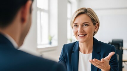 Businesswoman engaging in conversation with colleague in office
