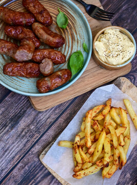  Home made   Fresh fried French fries and Grilled  meal on barbeque. on  wooden Background.  Sausages from minced meat,  on wooden rustic  background