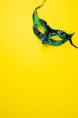 Blue Sequin Masquerade Mask on Yellow Background. Copy space