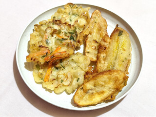 Gorengan, a traditional Indonesian street food consisting of fried bananas and bakwan (fried...