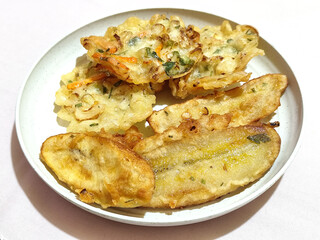 Gorengan, a traditional Indonesian street food consisting of fried bananas and bakwan (fried...