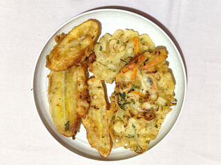 Gorengan, a traditional Indonesian street food consisting of fried bananas and bakwan (fried...