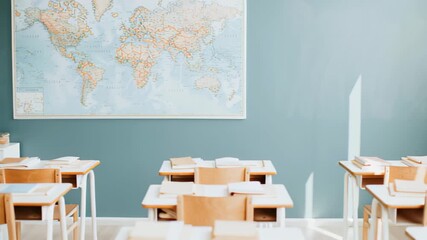 Empty classroom with world map and wooden desks in bright learning environment