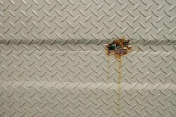 Close up of rusty perforated checkered plate. Copy space for text. Abstract patterns and textures. For graphic design, banners and 3D rendering