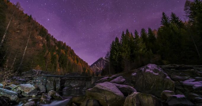 Night sky stargazing over San Giuseppe Italy showcasing a river rocks and trees in a landscape scenery.