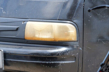 Close up of a car's headlights that look dull. For graphic design, banners and 3D rendering