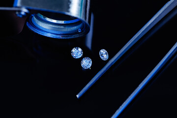 Brilliant diamonds and precision tools highlight sparkling gemstones lux black background