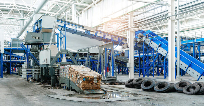 Modern recycling facility with automated conveyor systems and baled cardboard