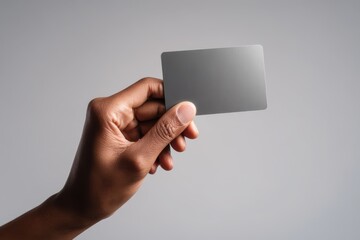 Diverse hand gripping a payment card in a clean studio shot