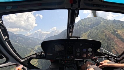 View from helicopter cockpit over the Alps, Switzerland, scenic landscape © Наталя Чернявська