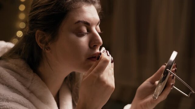 woman washes face and removes makeup with white cotton pad. Concept of facial skincare