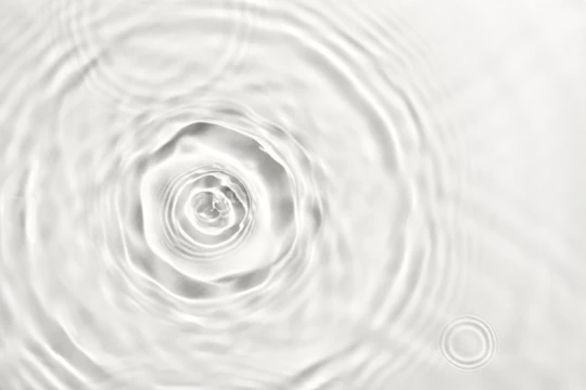 Water droplets creating ripples and waves on transparent background