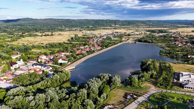 Scenic view of Tismana village in Gorj County Romania under a bright blue sky with fluffy clouds. A stunning landscape captures the beauty of Tismana village in Gorj County. Tismana, Romania.
