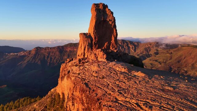 iconic Roque Nublo in Gran Canaria at sunset aerial view, vacation in Gran Canaria, the Canary Islands, Spain, volcanic rock in Gran Canaria, hiking in the Canaries 