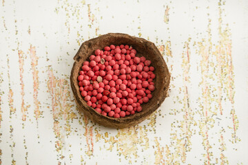 A pile of carrot seeds in a peat bowl. Flat lay