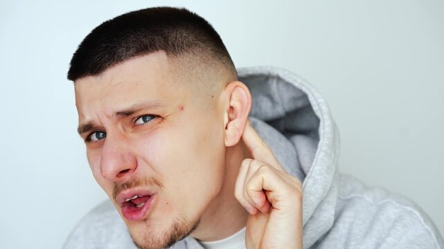 The man can't hear what's being said to him.
Hearing problems.
The man can't hear when people speak quietly.