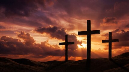 Three wooden crosses on a hill against a dramatic sunset sky. Religious concept for Easter, Good Friday, redemption, and Christianity.