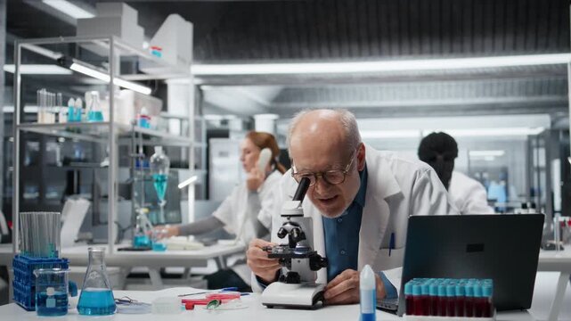 Histology technician analyzing bacterial culture slide to test antibiotic efficacy. Elderly man observing reaction under lens to develop new medical treatments, taking notes, camera A