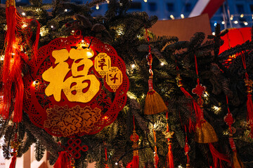 Traditional details of red gold Chinese New Year signs hanging outside, Asian festive decor