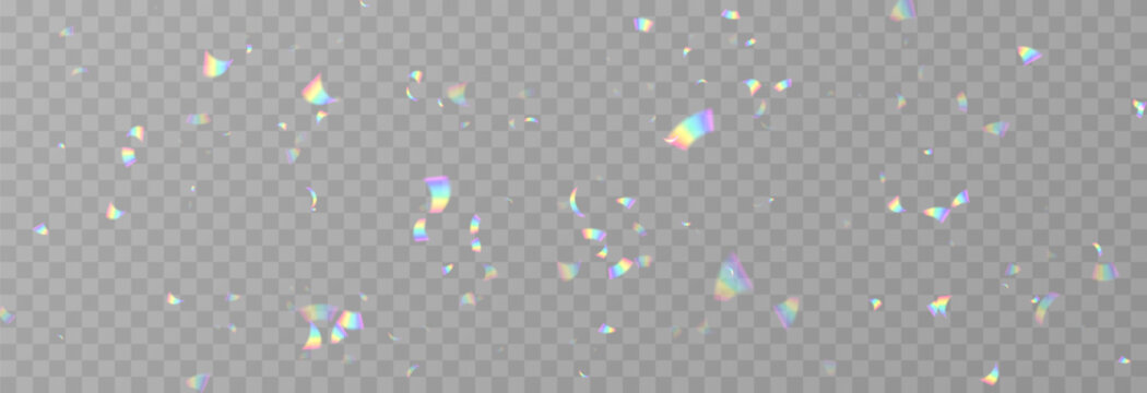 Falling holographic confetti. Shiny rainbow confetti PNG. Falling streamers or tinsel on an isolated transparent background.