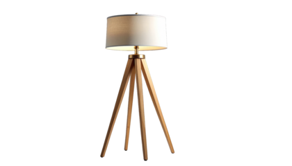 A wooden tripod lamp with a cream shade emits warm light, isolated on black