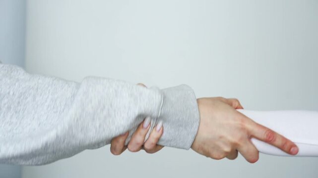 A man and a woman hold hands tightly.
People don't let go and are afraid of separation.
Mutual support and friendship.
Support and salvation