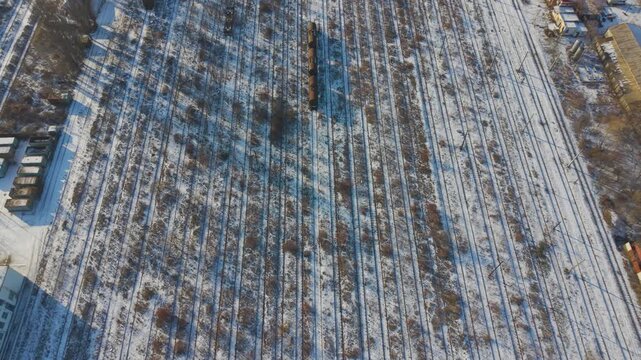 Aerial view of multiple parallel railway tracks covered in snow at the Socola rail yard in Iasi, Romania