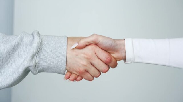 A greeting gesture with hands.
A man and a woman greet each other and shake hands.
Touching hands