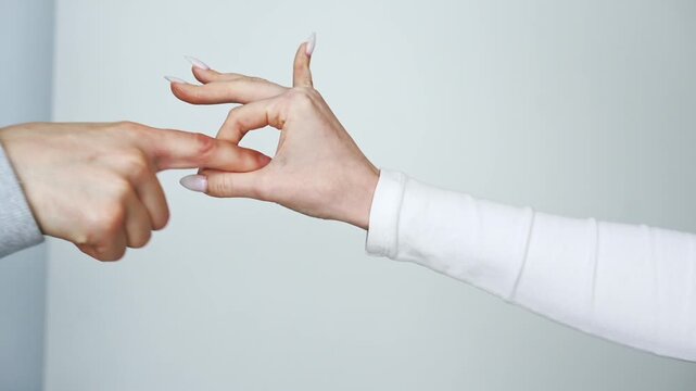 A gesture of simulating sex with hands.
A man and woman demonstrate sex with their hands and fingers.
A gesture of sex with their hands