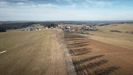 4K drone gliding forward over Vitto Tuttlingen farmland fields. Premium rural aerial with dry crops, field paths, tree shadows, and rolling hills. Ideal for agriculture, corporate, and travel content.