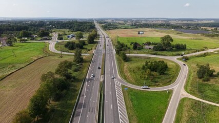 Aerial view of A1 highway exit and entrance ramps connecting rural road network
