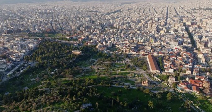 Cinematic high-altitude drone flight over the Stoa of Attalos and the Temple of Hephaestus in Athens, Greece. Ancient architecture, historic ruins, and golden light create a timeless scene for travel.