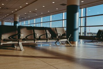 Empty waiting area with seats in a modern international airport terminal.