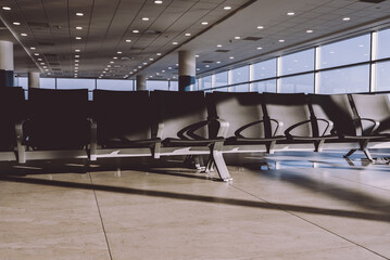Empty waiting area with seats in a modern international airport terminal.