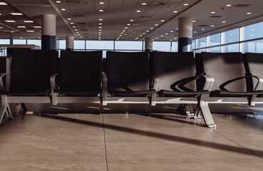 Empty waiting area with seats in a modern international airport terminal.