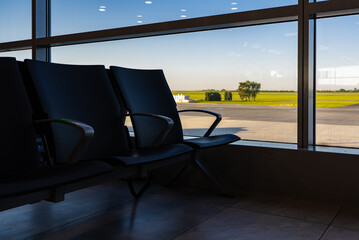 Empty waiting area with seats in a modern international airport terminal.