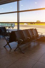 Empty waiting area with seats in a modern international airport terminal.